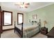 Bedroom featuring bright green walls, neutral carpeting, and windows providing natural light at 9237 N 500 W, Fountaintown, IN 46130