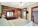 Charming bedroom with rustic wood accent wall, ceiling fan, and view into adjoining room at 9237 N 500 W, Fountaintown, IN 46130