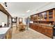 Spacious kitchen includes tile floors, wooden cabinets, and stainless steel refrigerator near a dining table and chairs at 9237 N 500 W, Fountaintown, IN 46130