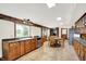 Well-lit kitchen featuring wooden cabinets, stainless steel appliances, a dining area, and large windows showcasing the landscape at 9237 N 500 W, Fountaintown, IN 46130