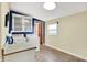 Bright laundry room equipped with washer, dryer, white cabinets, and a window allowing natural light and exterior views at 9237 N 500 W, Fountaintown, IN 46130