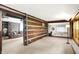 Inviting living room showcasing beautiful log walls and neutral carpet flooring at 9237 N 500 W, Fountaintown, IN 46130
