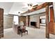 Inviting living room with exposed wooden beams, brick accents, and a comfortable seating arrangement at 9237 N 500 W, Fountaintown, IN 46130