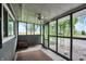 Enclosed porch featuring screens, ceiling fan, neutral rug and views of backyard at 9237 N 500 W, Fountaintown, IN 46130