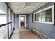 Screened porch with ceiling fan, offering outdoor access and views of backyard at 9237 N 500 W, Fountaintown, IN 46130