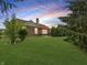 Large backyard featuring a well-maintained lawn, mature trees, and patio with a grill at 9302 N Bayland Dr, McCordsville, IN 46055