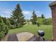 Landscaped backyard featuring a patio with a grill and lush lawn with mature trees at 9302 N Bayland Dr, McCordsville, IN 46055