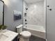 Bathroom featuring marble-look tile, a navy vanity, and new fixtures at 9302 N Bayland Dr, McCordsville, IN 46055