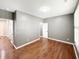 Spacious bedroom boasts gleaming hardwood floors, neutral paint, and bright window with shutters at 9302 N Bayland Dr, McCordsville, IN 46055