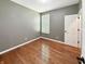 Neutral bedroom with hardwood floors, white window shutters and a white door at 9302 N Bayland Dr, McCordsville, IN 46055