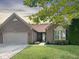 Charming one-story brick home with a well-manicured lawn and an attached garage at 9302 N Bayland Dr, McCordsville, IN 46055