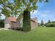 Well-manicured lawn and landscaping add curb appeal to this lovely brick home at 9302 N Bayland Dr, McCordsville, IN 46055