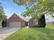 Charming one-story brick home with a well-manicured lawn and an attached garage at 9302 N Bayland Dr, McCordsville, IN 46055