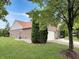Brick house with a well-manicured lawn, beautiful landscaping, and an attached garage at 9302 N Bayland Dr, McCordsville, IN 46055