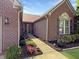 Charming brick home featuring a well-manicured lawn, flowers and walkway to the front door at 9302 N Bayland Dr, McCordsville, IN 46055