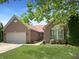 Charming brick home featuring an attached garage, a beautifully landscaped yard, and a welcoming walkway at 9302 N Bayland Dr, McCordsville, IN 46055
