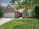 Charming brick home featuring an attached garage, a beautifully landscaped yard, and a welcoming walkway at 9302 N Bayland Dr, McCordsville, IN 46055