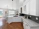 Bright kitchen features granite counters, modern appliances, and dark backsplash, adjacent to dining and living areas at 9302 N Bayland Dr, McCordsville, IN 46055