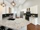 Updated kitchen featuring stainless appliances, granite countertops, white cabinets, and a modern black backsplash at 9302 N Bayland Dr, McCordsville, IN 46055