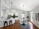 Modern kitchen and dining area with granite counters, stainless appliances, and modern light fixtures at 9302 N Bayland Dr, McCordsville, IN 46055