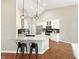 Bright open concept kitchen boasts stainless appliances, granite countertops, a black backsplash, and modern lighting at 9302 N Bayland Dr, McCordsville, IN 46055