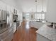 Bright, open kitchen with white cabinets, granite countertops, stainless steel appliances, and an island at 9302 N Bayland Dr, McCordsville, IN 46055