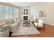 Inviting living room featuring a stone fireplace, hardwood floors, and comfortable seating, perfect for relaxation and entertaining at 9302 N Bayland Dr, McCordsville, IN 46055