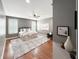 Serene main bedroom featuring hardwood floors, plantation shutters, and a plush rug, creating a cozy retreat space at 9302 N Bayland Dr, McCordsville, IN 46055