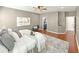 Spacious main bedroom with hardwood floors, a plush rug, and access to the ensuite bathroom and closet at 9302 N Bayland Dr, McCordsville, IN 46055