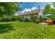 Spacious backyard with a well-kept lawn, a patio seating area, and a beautiful landscape creating an inviting outdoor space at 9520 Settlement W Dr, Indianapolis, IN 46250