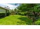 Expansive backyard with a lush green lawn, mature trees, and inviting seating areas for outdoor relaxation at 9520 Settlement W Dr, Indianapolis, IN 46250
