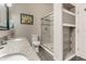 Nicely remodeled bathroom featuring double sinks, tiled shower, and modern fixtures at 9520 Settlement W Dr, Indianapolis, IN 46250
