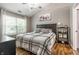 Bright bedroom with a queen bed, vaulted ceiling, and large window overlooking the yard at 9520 Settlement W Dr, Indianapolis, IN 46250