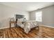 Comfortable bedroom with hardwood floors, queen bed, and natural light at 9520 Settlement W Dr, Indianapolis, IN 46250