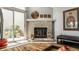 Stone fireplace features glass doors, wood mantle, and adjacent sliding glass door to patio at 9520 Settlement W Dr, Indianapolis, IN 46250