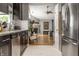 Well-appointed kitchen with stainless appliances and an open view into the living area and fireplace at 9520 Settlement W Dr, Indianapolis, IN 46250