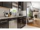 Updated kitchen with stainless steel appliances, granite countertops, and view to the living room at 9520 Settlement W Dr, Indianapolis, IN 46250