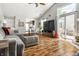 Open concept living room with cozy gray sofa, fireplace, and large windows at 9520 Settlement W Dr, Indianapolis, IN 46250