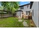 Grassy backyard featuring a picnic table and a wooden deck with steps at 953 E 34Th St, Indianapolis, IN 46205