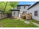 Home's backyard featuring a small deck with stairs, patio, and grassy area at 953 E 34Th St, Indianapolis, IN 46205