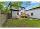 Lush backyard with a patio area, picnic table, and a wooden deck at 953 E 34Th St, Indianapolis, IN 46205