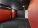 Basement featuring a dark ceiling, red accent wall, and black carpeting at 953 E 34Th St, Indianapolis, IN 46205