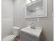 Cozy half bath featuring a modern vanity and toilet with beadboard paneling at 953 E 34Th St, Indianapolis, IN 46205