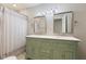 Bright bathroom featuring a double sink vanity with sage cabinetry and modern fixtures at 953 E 34Th St, Indianapolis, IN 46205