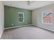 Spacious bedroom with neutral carpet, large windows offering natural light, and a modern ceiling fan at 953 E 34Th St, Indianapolis, IN 46205