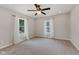 Well-lit bedroom with neutral carpet, dual windows, and a stylish ceiling fan at 953 E 34Th St, Indianapolis, IN 46205