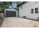 Side view of the home featuring a long concrete driveway and detached garage at 953 E 34Th St, Indianapolis, IN 46205