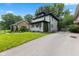 Charming two-story home with a lush front lawn and long driveway at 953 E 34Th St, Indianapolis, IN 46205