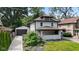 Charming two-story home with a covered front porch, neat landscaping, and a detached garage at 953 E 34Th St, Indianapolis, IN 46205
