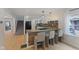 Well-lit kitchen with granite countertops, island, breakfast bar, and stainless steel appliances at 953 E 34Th St, Indianapolis, IN 46205